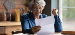 Woman reading post at home