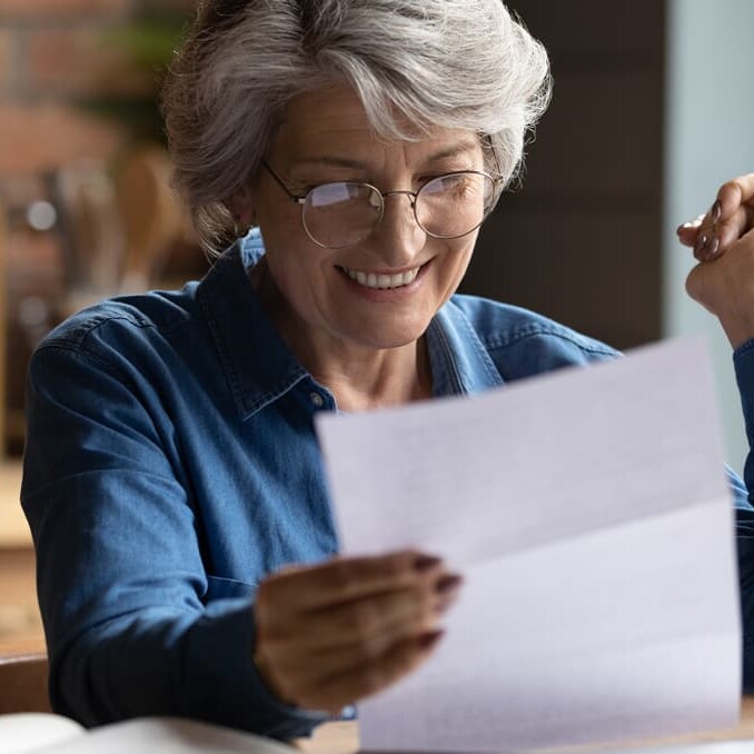 Woman reading post at home