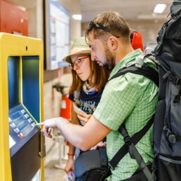 backpackers purchasing tickets