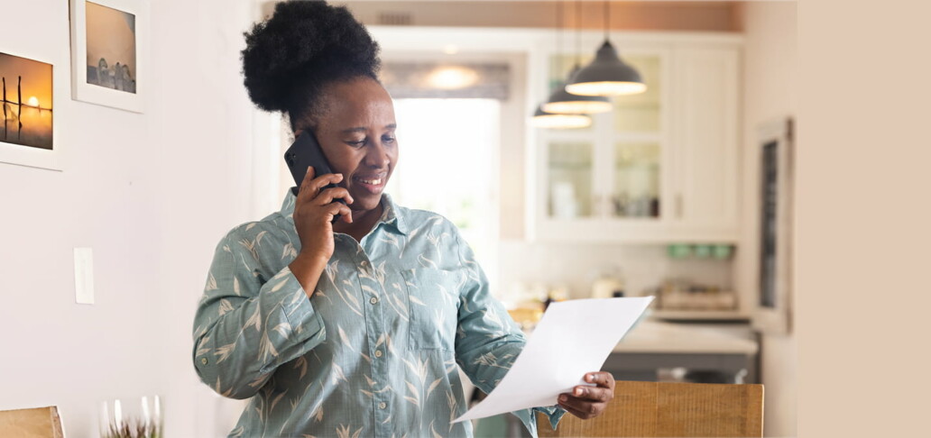 woman on phone with direct mail letter