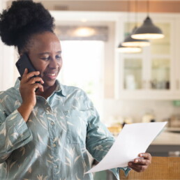 woman on phone with direct mail letter