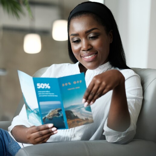 woman looking at travel brochure