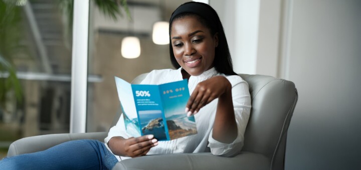 woman looking at travel brochure