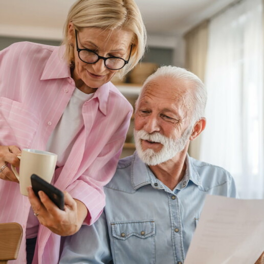couple looking at smart phone and direct mail