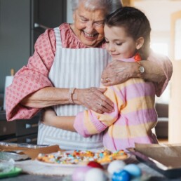 Grandmother and granddaughter hugging.