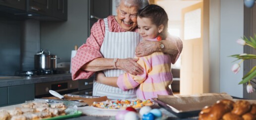Grandmother and granddaughter hugging.