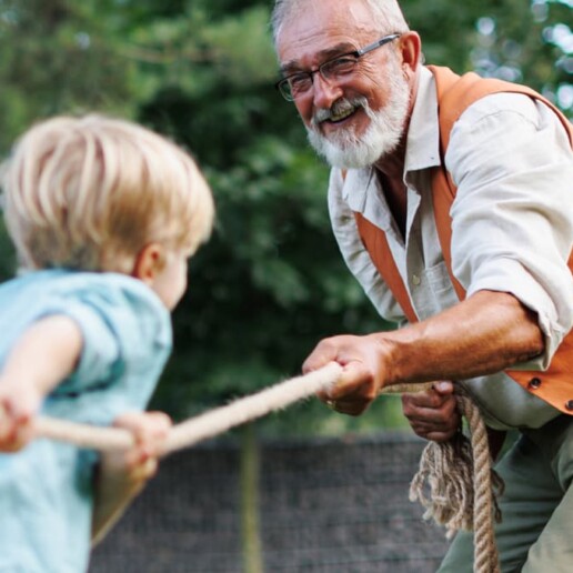 Man playing with grandchildren