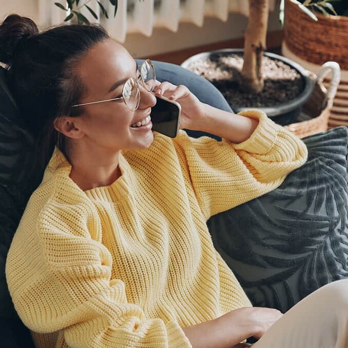 Woman on phone on beanbag chair