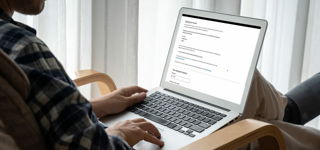 Person on laptop opting in to charity