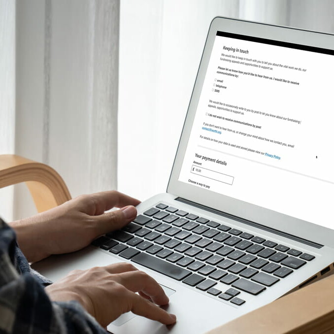 Person on laptop opting in to charity