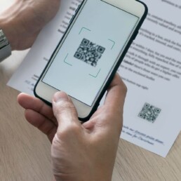 Person scanning the QR code on a direct mail