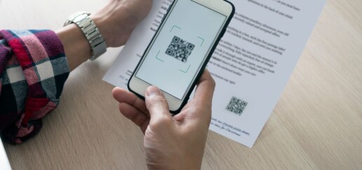 Person scanning the QR code on a direct mail