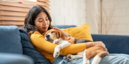 woman with dog on sofa